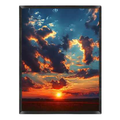 Vertical landscape art print depicting a dramatic sunset over a field, with glowing orange and red clouds against a deep blue sky, shown on a plain white background.