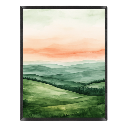 Watercolor landscape art print featuring rolling green hills, layered blue-green mountain ranges, and a soft peach and cream sky, presented in a black frame against a white background.