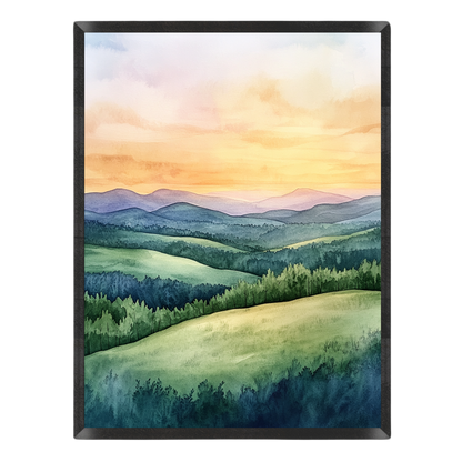 Watercolor landscape painting featuring rolling green hills, pine trees, and distant blue mountains under a warm orange and yellow sunset sky, presented in a black frame against a white background.